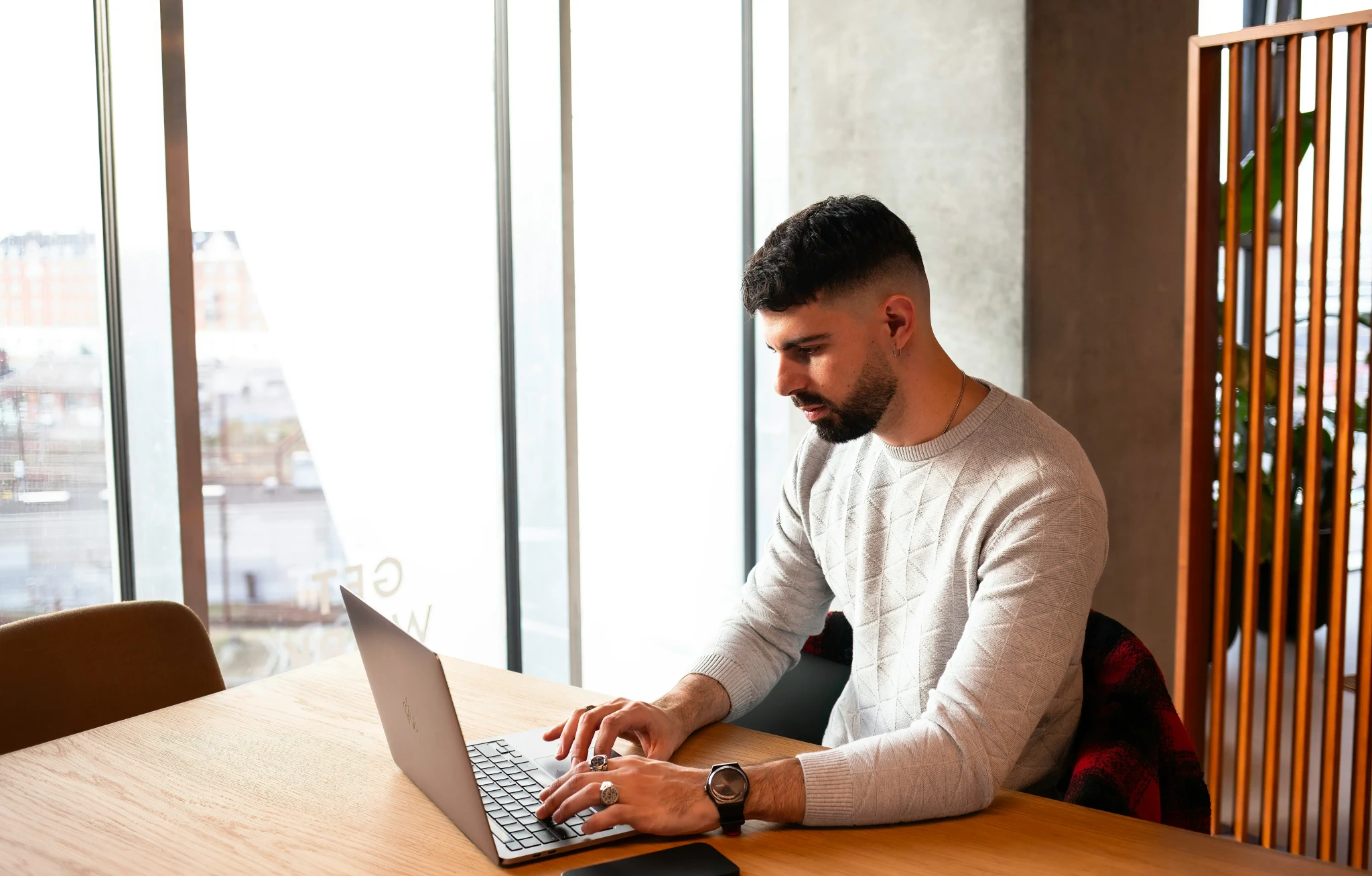 A service-based business owner reviewing their new custom website on a laptop.